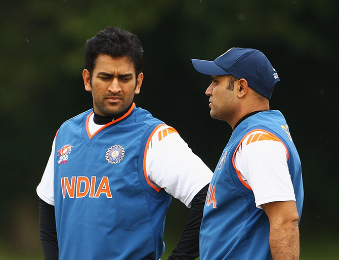India's MS Dhoni talks to Virender Sehwag during a nets session 