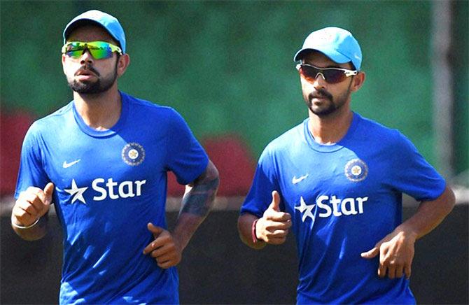 Virat Kohli and Ajinkya Rahane warm up during a practice session