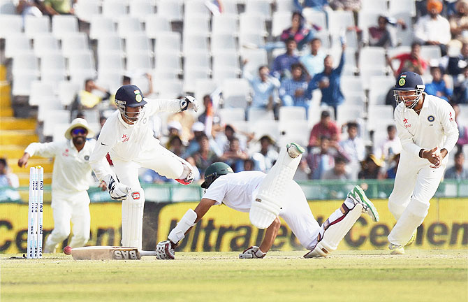 Wriddhiman Saha stumps Hashim Amla during the Mohali Test, November 6, 2015. Photograph: Manvender Vashist/PTI