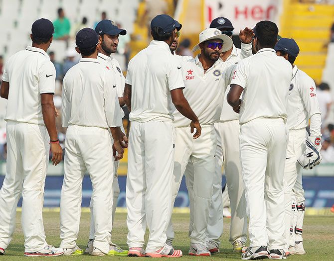 Indian players celebrate the fall of a South Africa wicket