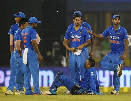 India's players look on as play is suspended due to crowd trouble during the second T20 International in Cuttack on October 7
