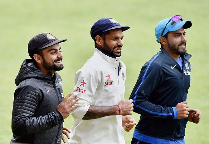 India's skipper Virat Kohli with teammates Shikhar Dhawan and Ravindra Jadeja during a training session at the Chinnaswamy Stadium in Bengaluru on Friday