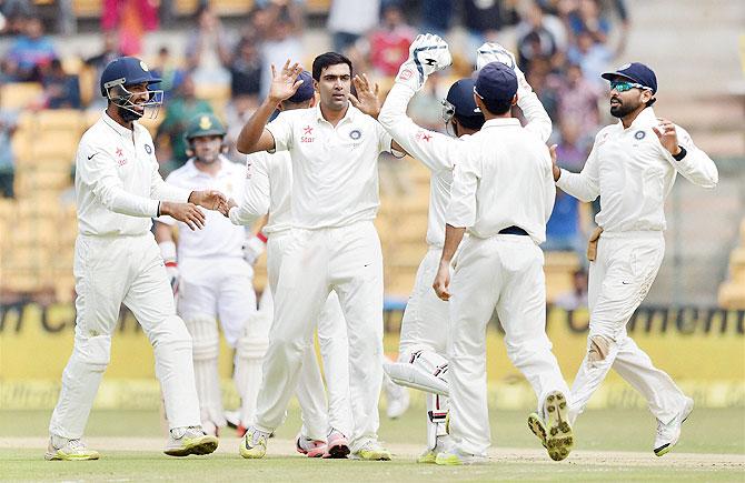 India's Ravichandran Ashwin and with teammates celebrate the wicket of South Africa's Stiaan Van Zyl