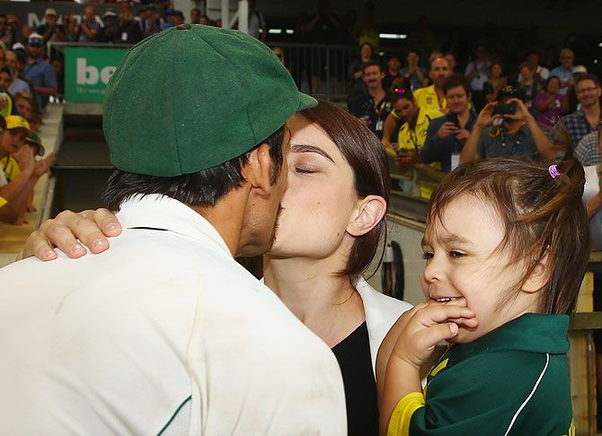 Mitchell Johnson of Australia is greeted by his wife Jessica and daughter Rubika 