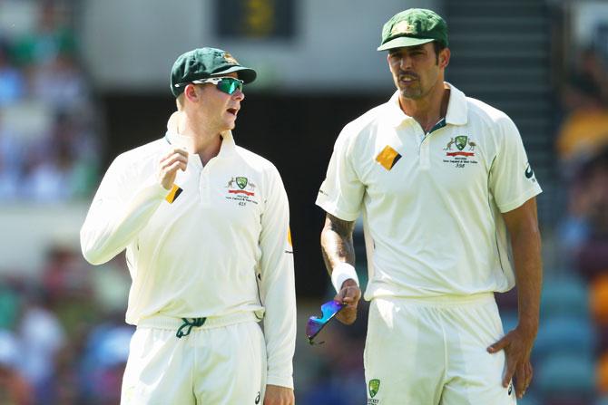 Australia Test captain Steve Smith speaks to pacer Mitchell Johnson