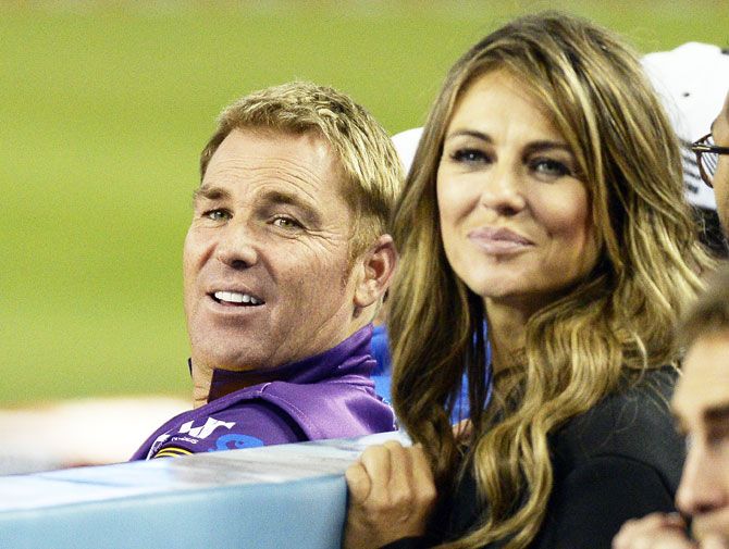 Actress Elizabeth Hurley (right) poses with Shane Warne the during the final game of a three-match, three city US tour of Twenty20 series of Cricket All-Stars Series game between Shane's Warriors and Sachin's Blasters at Dodger Stadium in Los Angeles, on Saturday