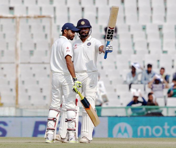 Murali Vijay (right) celebrates his half-century with Ravindra Jadeja in the first Test in Mohali