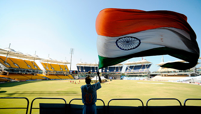 A fan waves a flag during an Indian team training session at the MA Chidambaram stadium in Chennai 