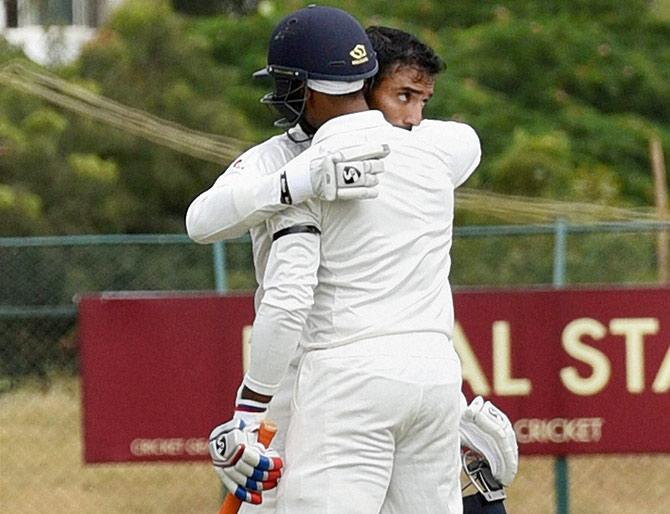 Karnataka'ss Robin Uthappa celebrates after completing his century 