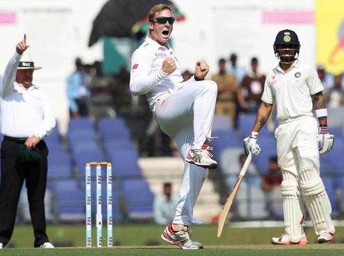 South Africa's Simon Harmer celebrates after dismissing Cheteshwar Pujara