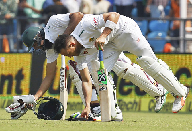 South Africa's captain Hashim Amla (left) and his teammate Faf du Plessis get ready to bat on Day 3 of their third Test match against India in Nagpur on Friday