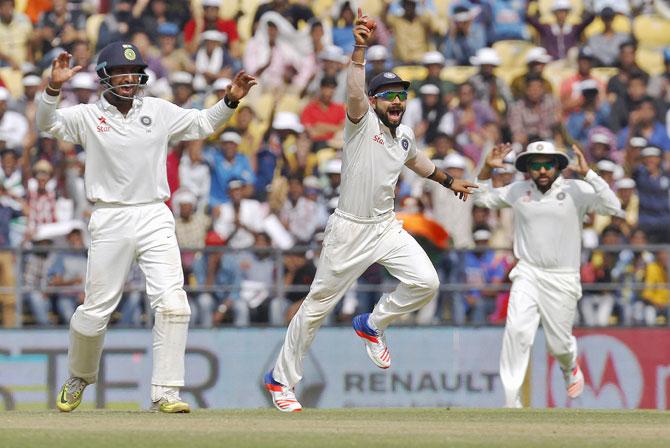 India's captain Virat Kohli (centre) along with his teammates Cheteshwar Pujara (left) and Rohit Sharma appeal unsuccessfully for the wicket of South Africa's Faf du Plessis