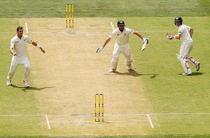 Shaun Marsh and Steve Smith of Australia get caught in the middle of the pitch as Marsh is run out by New Zealand's Brendon McCullum