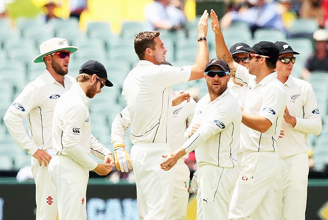 New Zealand's Tim Southee is congratulated by teammates after getting the wicket of Australia's Adam Voges