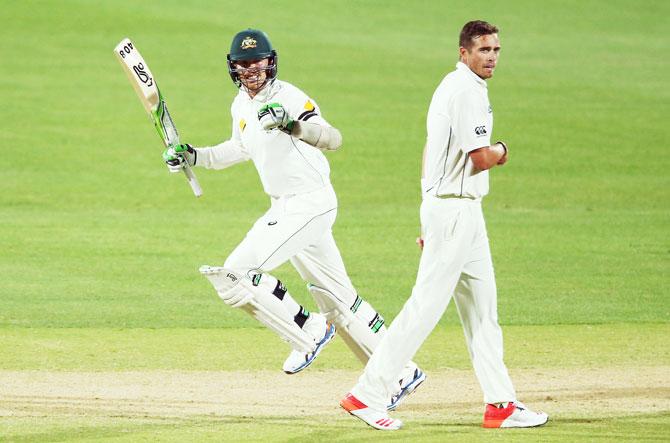 Australia's Peter Siddle celebrates after hitting the winning runs as New Zealand's Tim Southee looks on on Day 3 of the Third Test at Adelaide Oval in Adelaide on Sunday