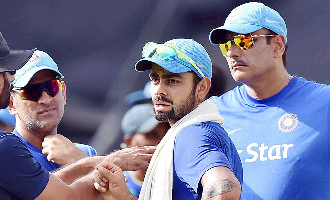 Indian captain Mahendra Singh Dhoni, Virat Kohli and Team Director Ravi Shastri during a training session