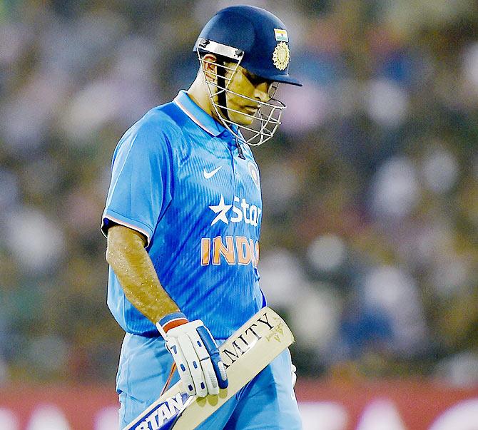 Mahendra Singh Dhoni walks back after his dismissal