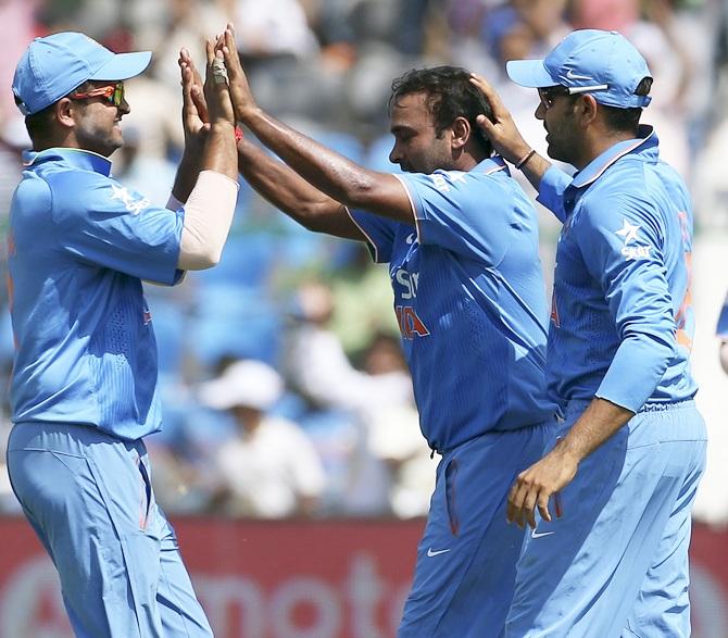 India's Suresh Raina,left, Amit Mishra, centre, and Rohit Sharma