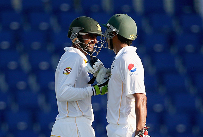 Shoaib Malik is congratulated by Younis Khan after reaching his century  