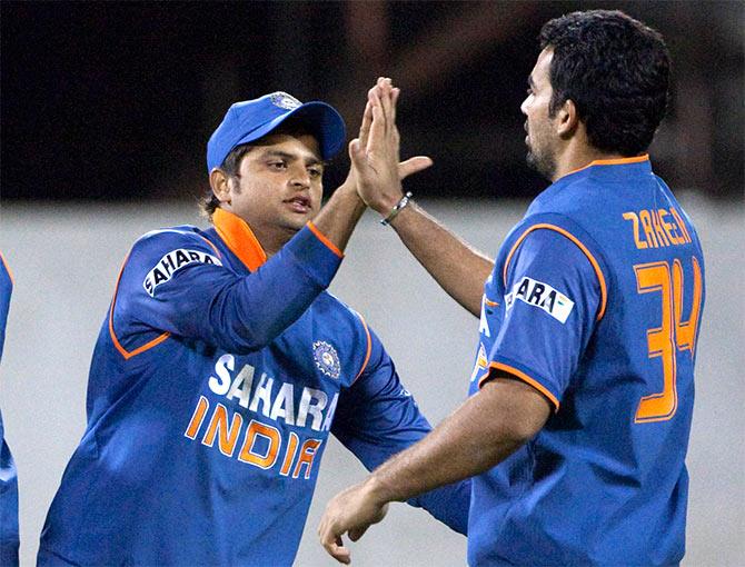 India's Suresh Raina and Zaheer Khan (right) celebrate a dismissal 