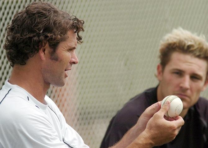 Brendon McCullum, right, watches Chris Cairns 