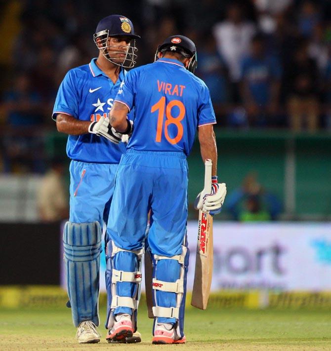 India's Captain Mahendra Singh Dhoni with Virat Kohli in the third ODI in Rajkot, October 18.