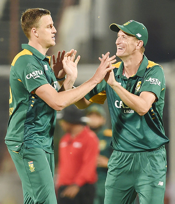 South African bowler Morkel (left) celebrates the wicket of India's Virat Kohli