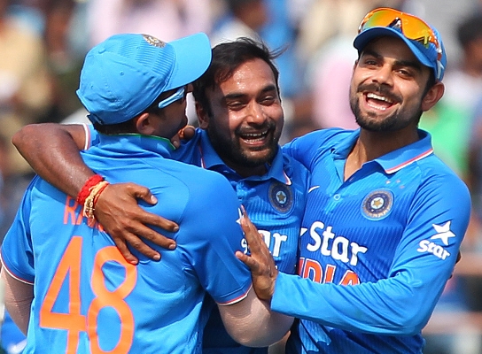 India's Amit Mishra and Virat Kohli celebrate the fall of a South African wicket 