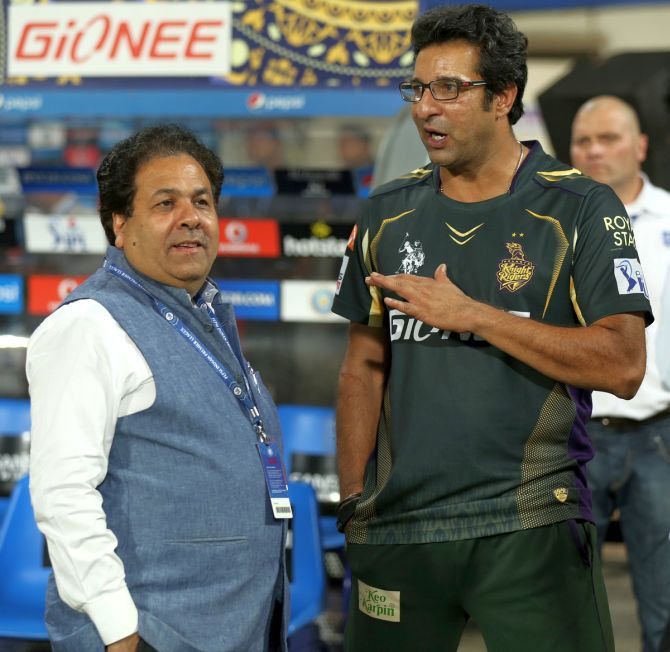 Rajeev Shukla talks to Wasim Akram during an IPL game