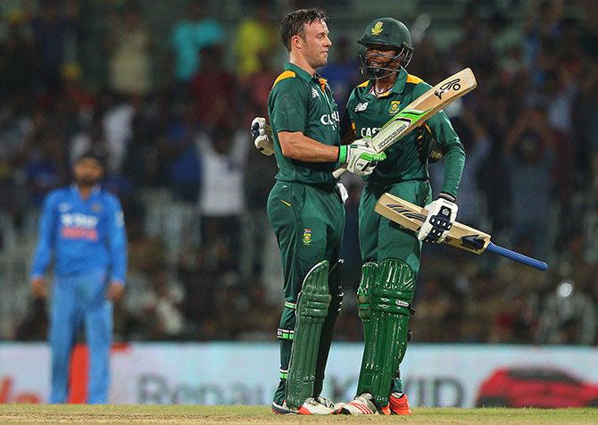 South Africa captain AB de Villiers celebrates his century with Aaron Phangiso during the fourth ODI against India in Chennai