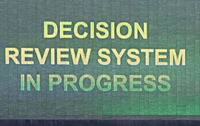 A giant screen at a cricket venue flashes the request for review during a match