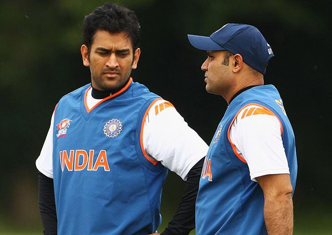 Mahendra Singh Dhoni talks to Virender Sehwag during a nets session