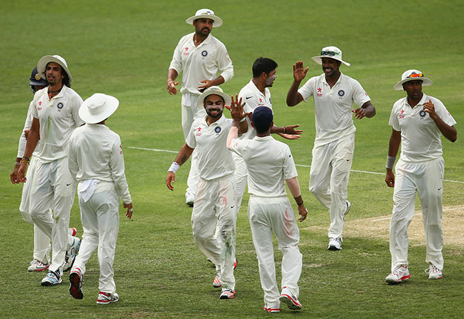 India's Virat Kohli celebrates with team mates after the fall of a wicket 