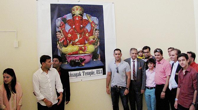 Indian cricketer Mahendra Singh Dhoni (centre) and his wife Sakshi (left) with devotees at Sidhhivinayak Temple in New Jersey on Sunday