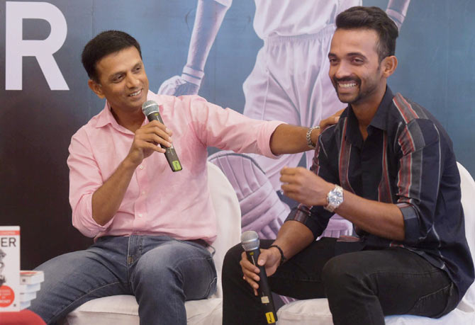 IMAGE: Former India captain Rahul Dravid jokes with Ajinkya Rahane during the launch of former cricketer Akash Chopra's book 'The Insider', in Mumbai on Friday