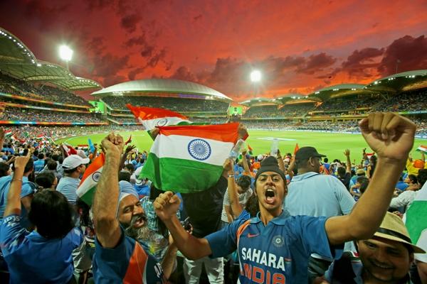 Indian fans in the crowd celebrate 