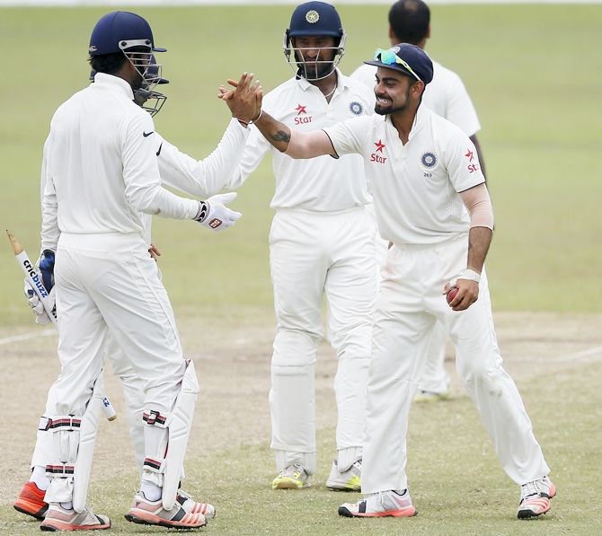 Captain Virat Kohli, right, celebrates with teammates after India's victory over Sri Lanka 
