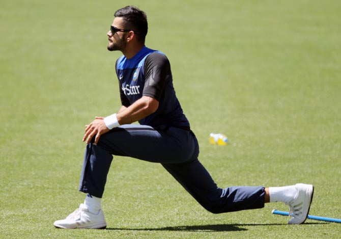 Virat stretches during a Team India training session