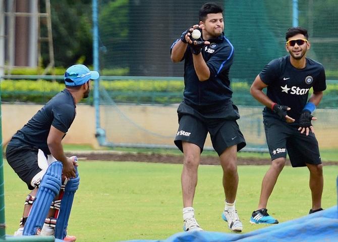 India's Suresh Raina, centre, Unmukt Chand, right, and Kedar Jadhav during a practice session in Bengaluru