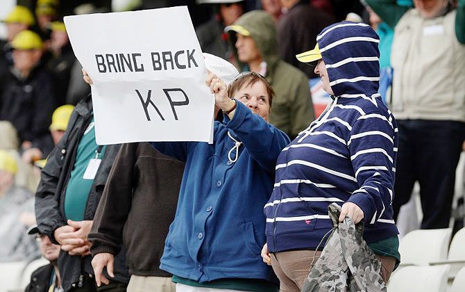 A woman holds up a sign in reference to Kevin Pietersen 