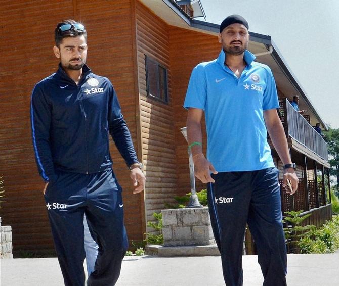  Virat Kohli, left, and Harbhajan Singh move to a hotel in Dharamshala 