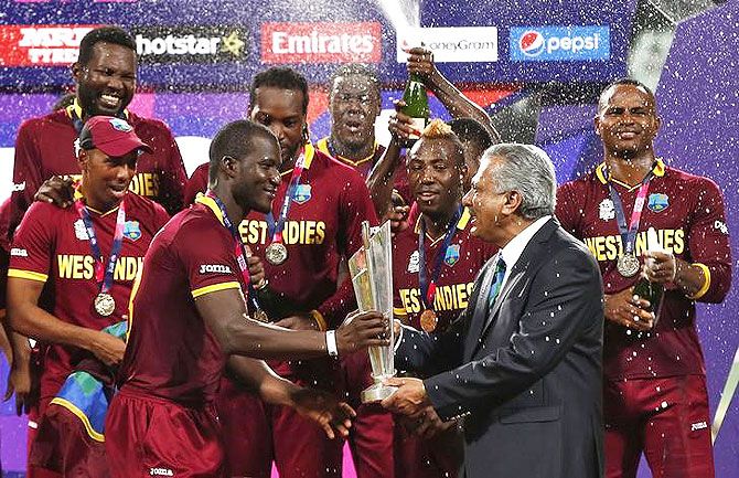 West Indies captain Darren Sammy receives the trophy from ICC President Zaheer Abbas