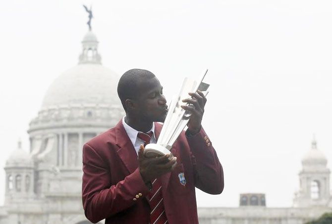 West Indies captain Darren Sammy kisses the cricket World Twenty20 trophy in front of Victoria Memorial monument during a photo op in Kolkata