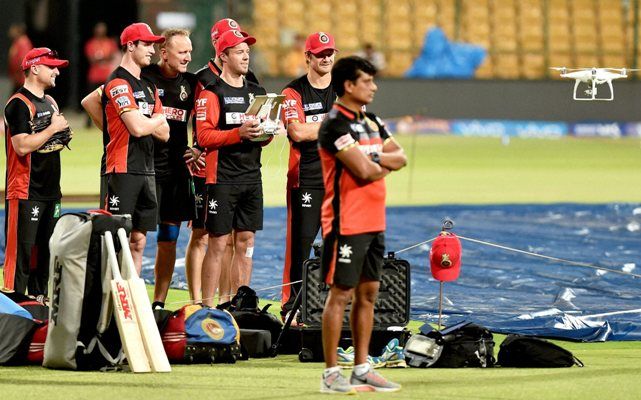 Royal Challengers Bangalore AB de Villiers operates a drone camera with Shane Watson during a training session in Bengaluru on Saturday