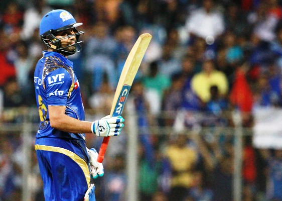 Mumbai Indians captain Rohit Sharma raises his bat after scoring a fifty