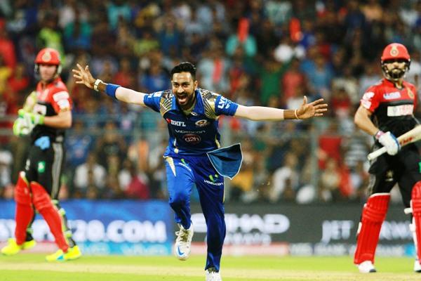 Mumbai Indians's Krunal Pandya celebrates the wicket of Royal Challengers Bangalore captain Virat Kohli