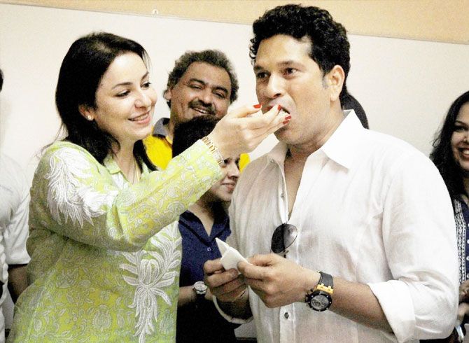 Master blaster Sachin Tendulkar is offered cake by his wife Anjali during his 43th birthday celebration with children from the Make-A-Wish India organisation in Mumbai on Sunday