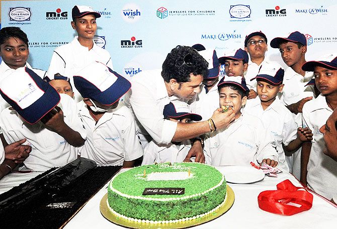 Sachin Tendulkar offers cake to the children from the Make-A-Wish India organisation in Mumbai on Sunday