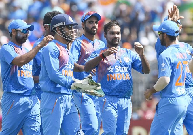 India's Amit Mishra celebrates a wicket with his teammates
