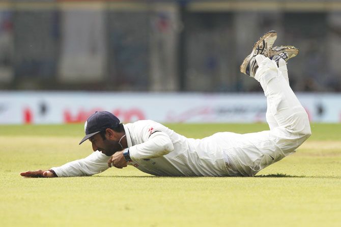 Cheteshwar Pujara dives to field a ball on Day 1 of the 5th Test against England in Chennai on Friday